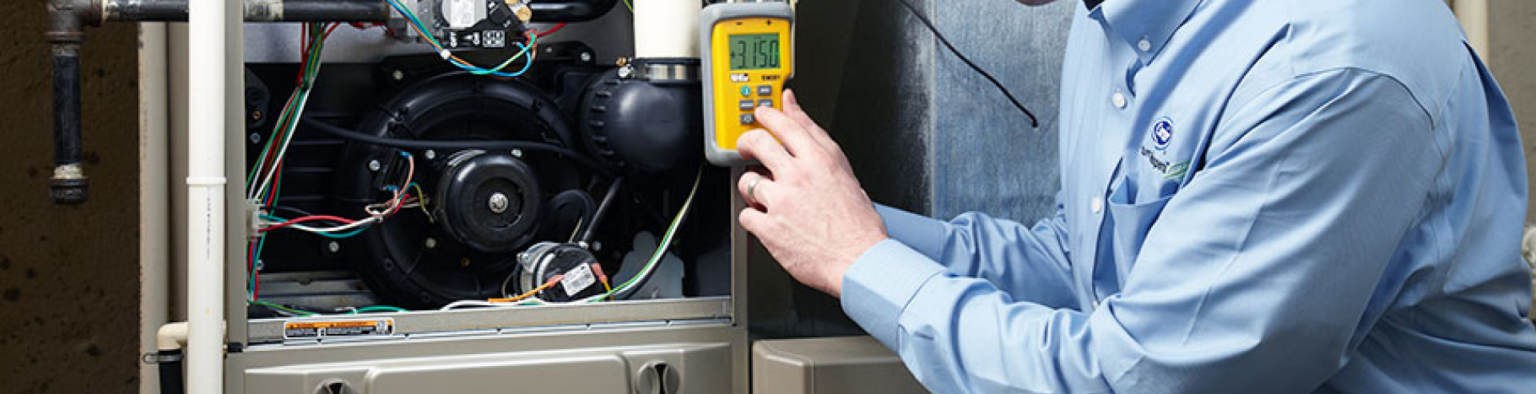 Energy Saver Solutions technician working on a home heating system